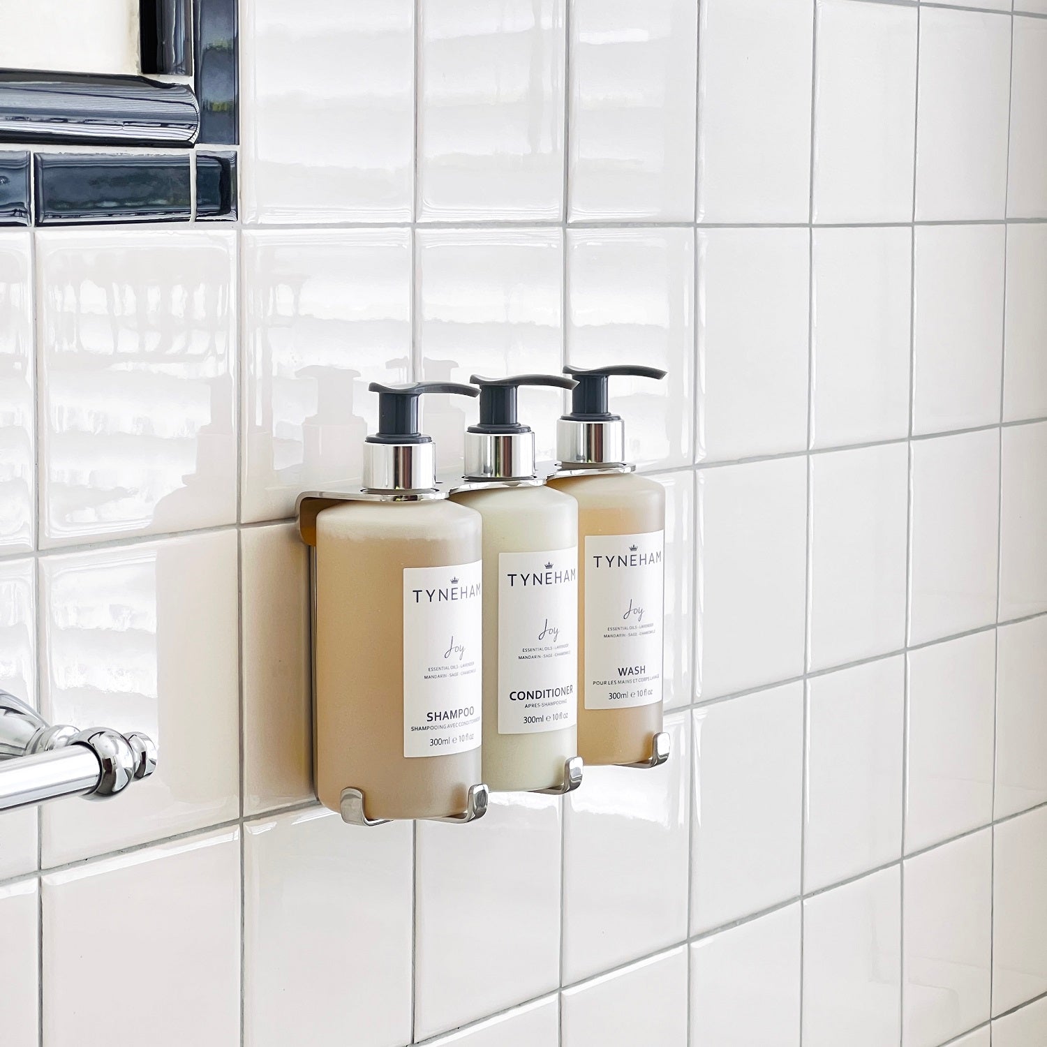 Tyneham joy hand and body wash bottle with pump on a light gray background